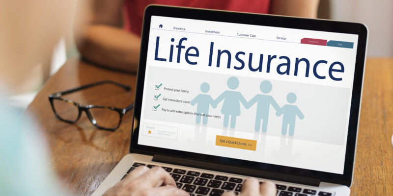 A laptop with a screen with the word "life insurance"
